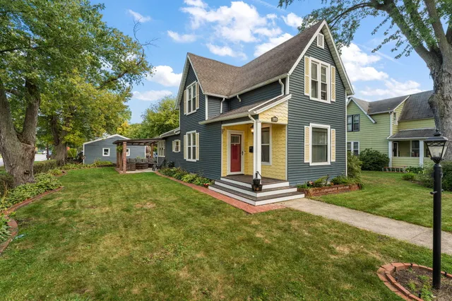 a front view of house with yard and green space