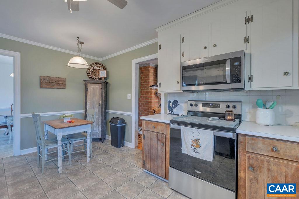 405 Christian Springs Road Amherst, VA 24521 - Photo 17 of 57 a kitchen with stainless steel appliances granite countertop a stove top oven a refrigerator a sink and a microwave
