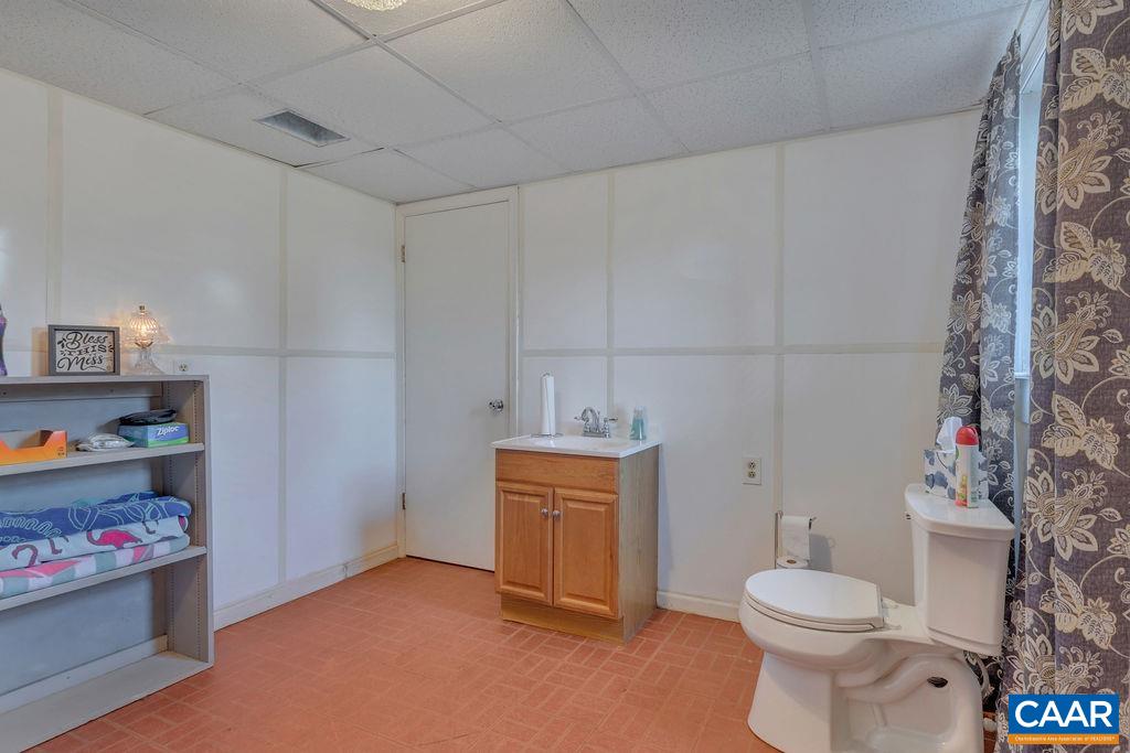 405 Christian Springs Road Amherst, VA 24521 - Photo 41 of 57 a bathroom with a toilet and a shower curtain