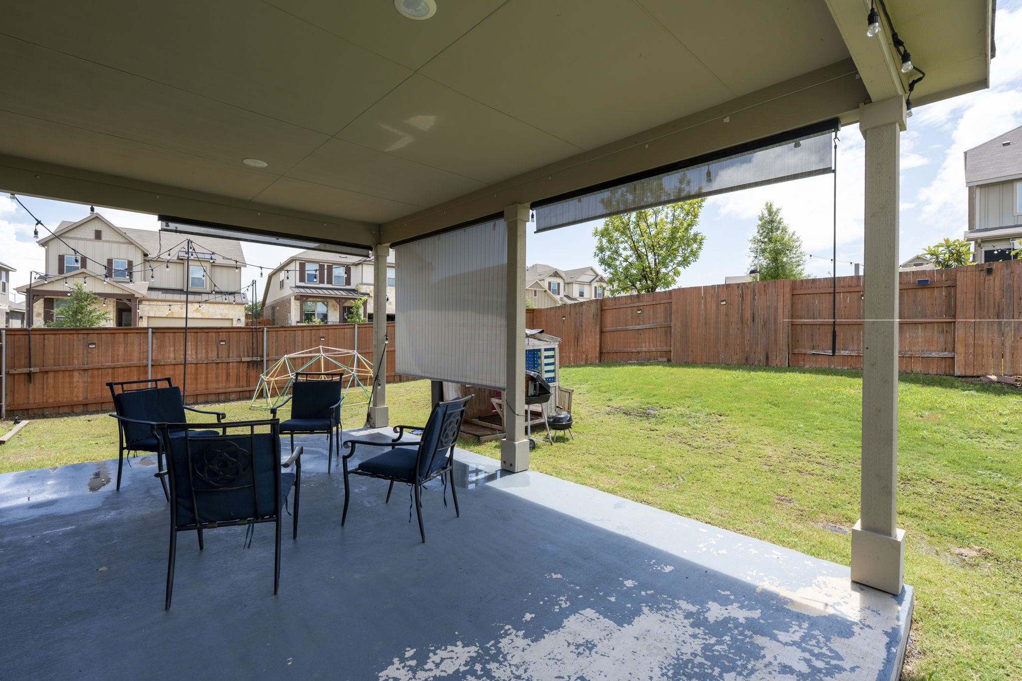 548 Purple Heart Drive Buda, TX 78610 - Photo 26 of 35 A spacious backyard with a private fence, featuring a covered patio for outdoor gatherings.