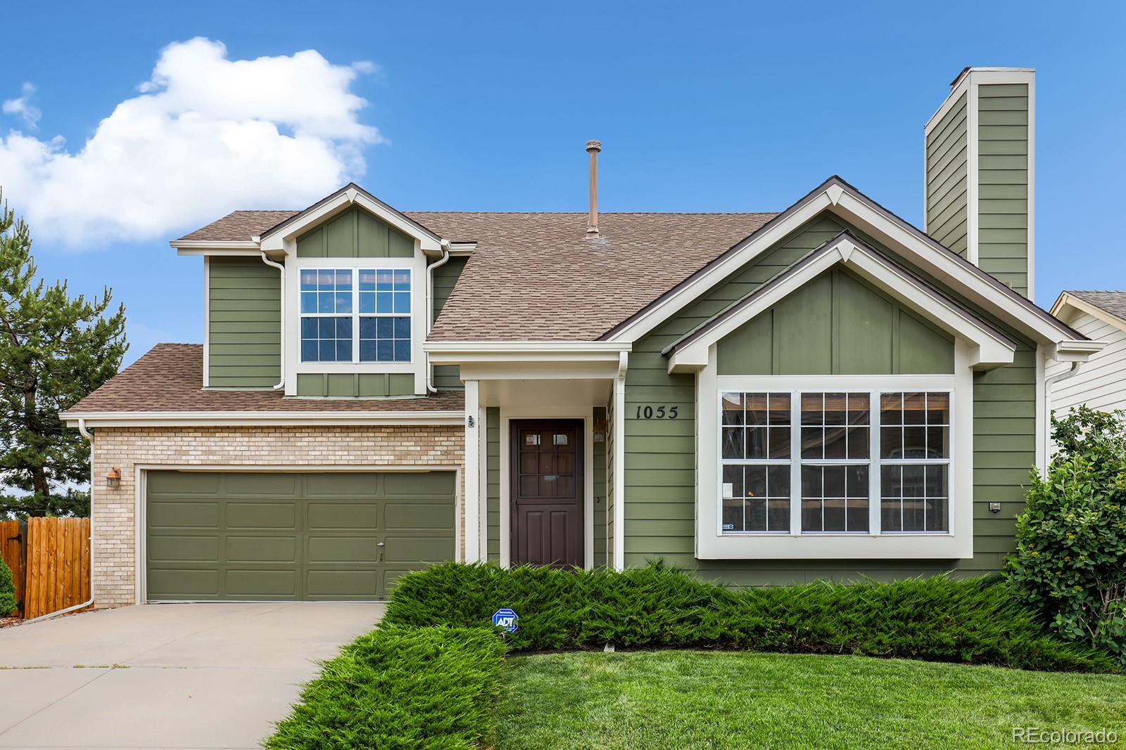 1055 Cobblestone Drive Highlands Ranch, CO 80126 - Photo 1 of 31 a front view of a house with garden
