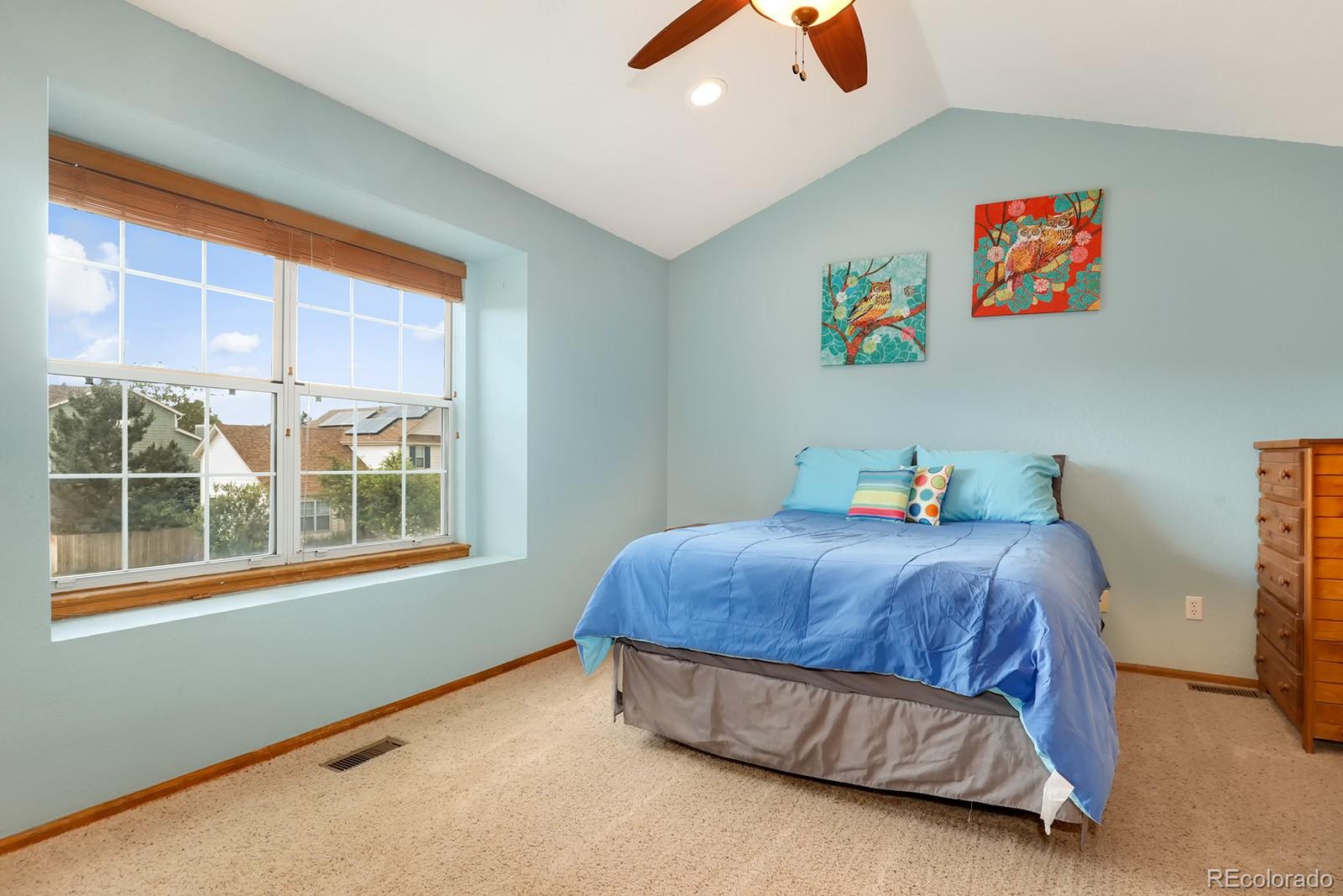 1055 Cobblestone Drive Highlands Ranch, CO 80126 - Photo 13 of 31 a bedroom with a bed and a window
