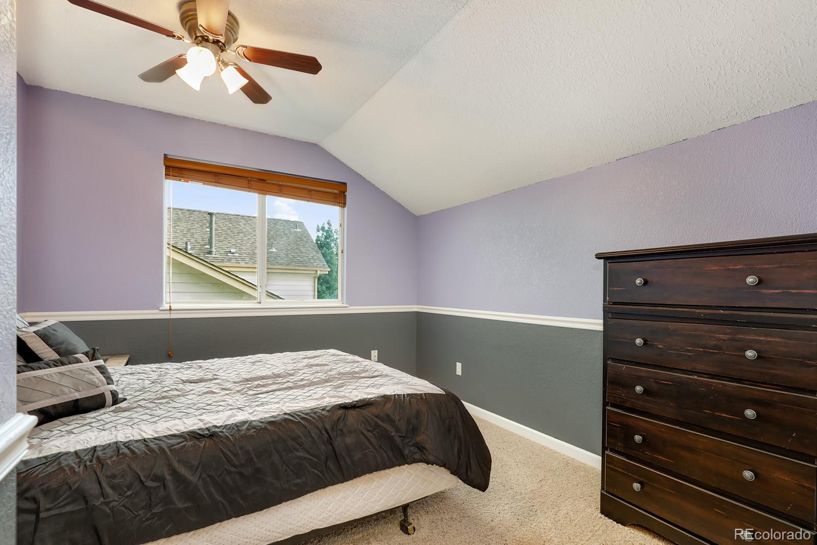 1055 Cobblestone Drive Highlands Ranch, CO 80126 - Photo 17 of 31 a bedroom with a bed and window