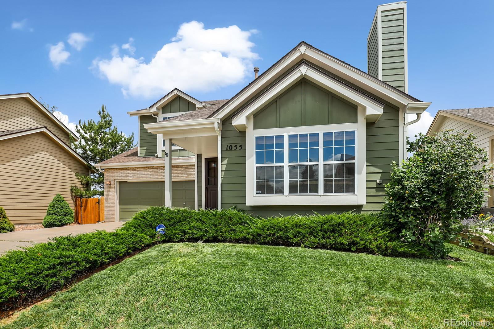 1055 Cobblestone Drive Highlands Ranch, CO 80126 - Photo 2 of 31 a front view of a house with garden