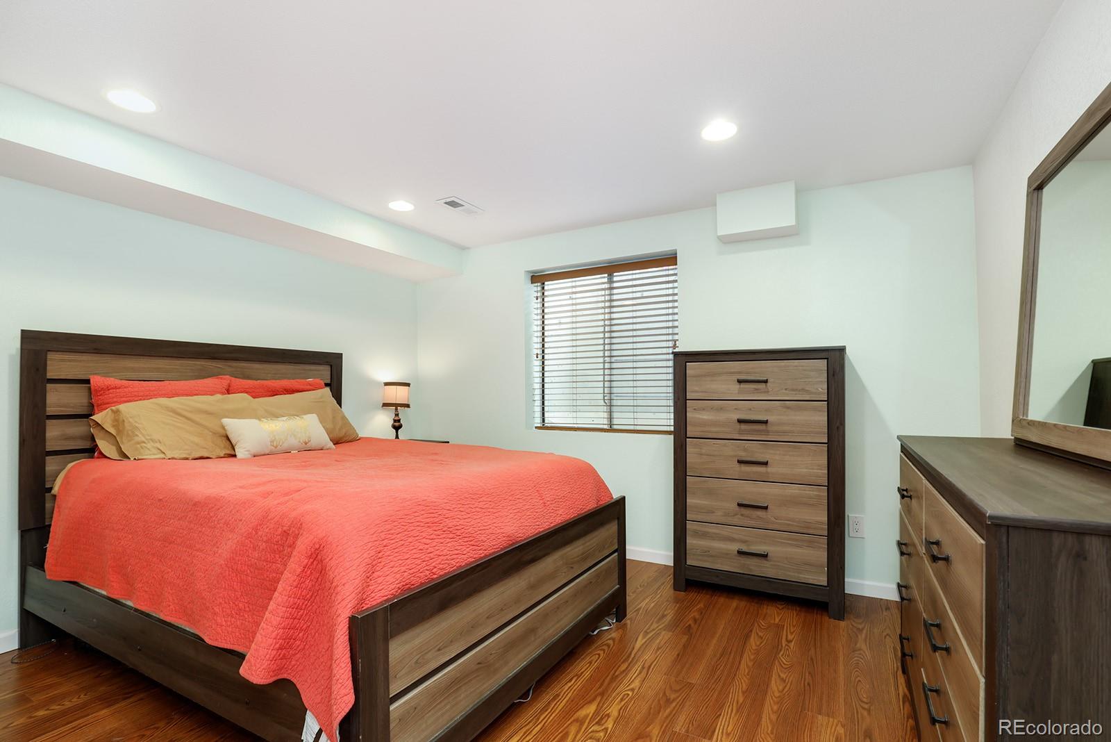 1055 Cobblestone Drive Highlands Ranch, CO 80126 - Photo 24 of 31 a bedroom with a bed and a dresser