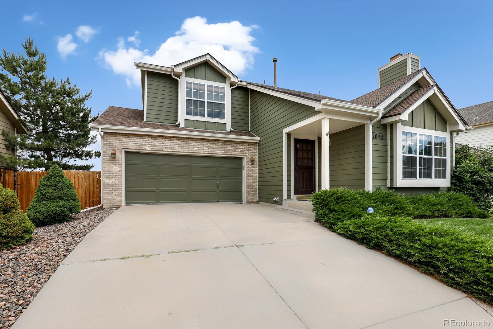 1055 Cobblestone Drive Highlands Ranch, CO 80126 - Photo 3 of 31 a front view of a house with yard