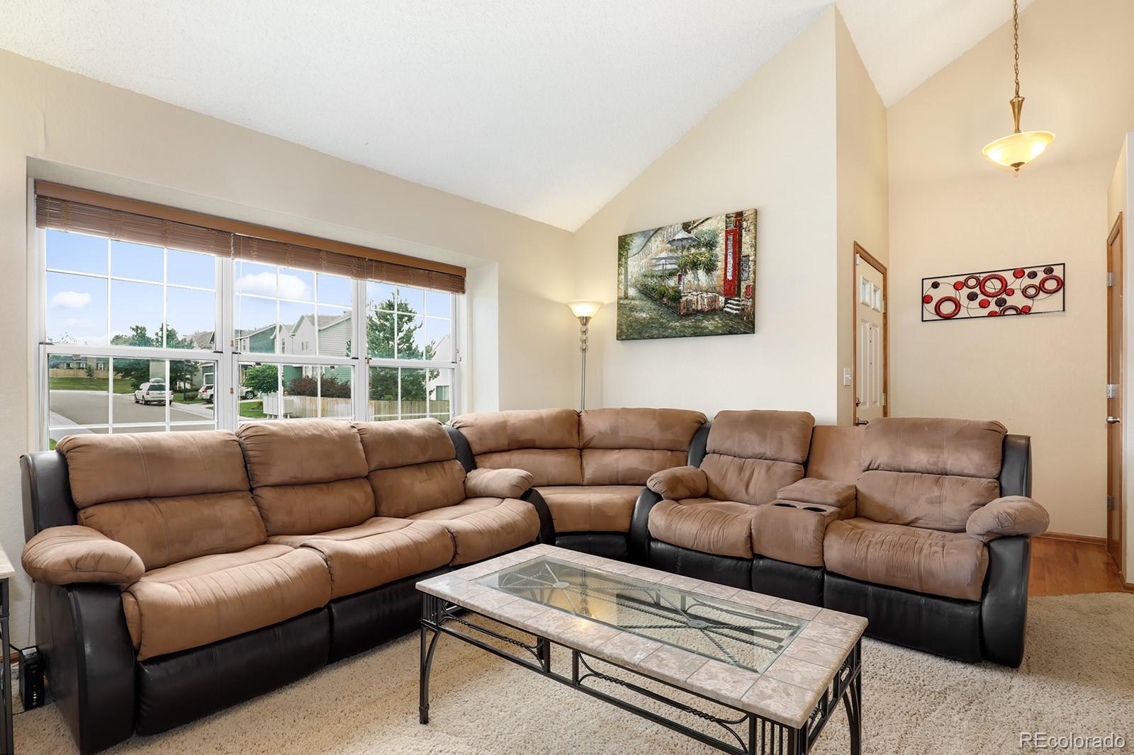 1055 Cobblestone Drive Highlands Ranch, CO 80126 - Photo 5 of 31 a living room with furniture and a large window