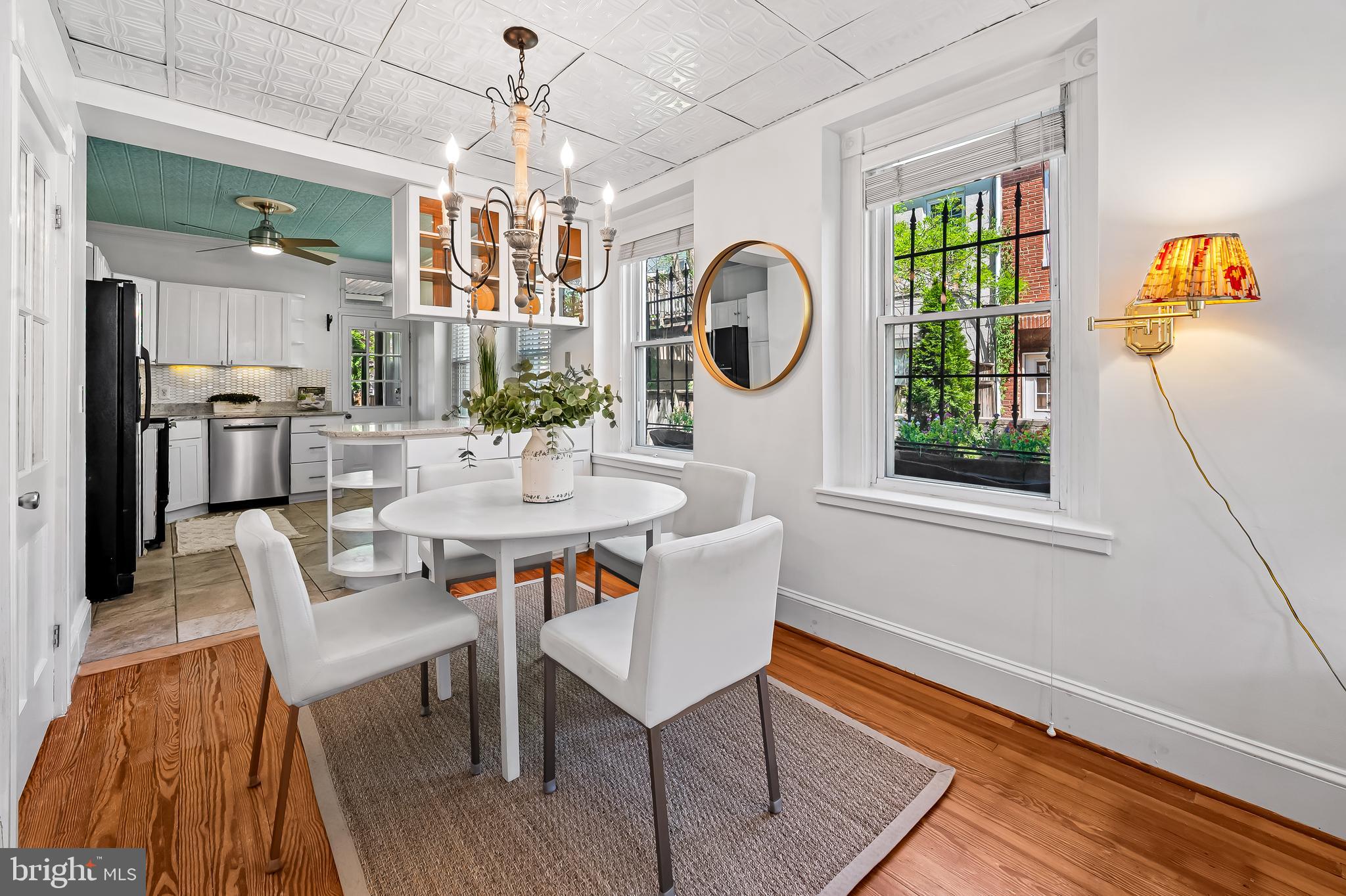 748 Ramsay Street Baltimore, MD 21230 - Photo 12 of 36 a dining room with chandelier fan and wooden floor