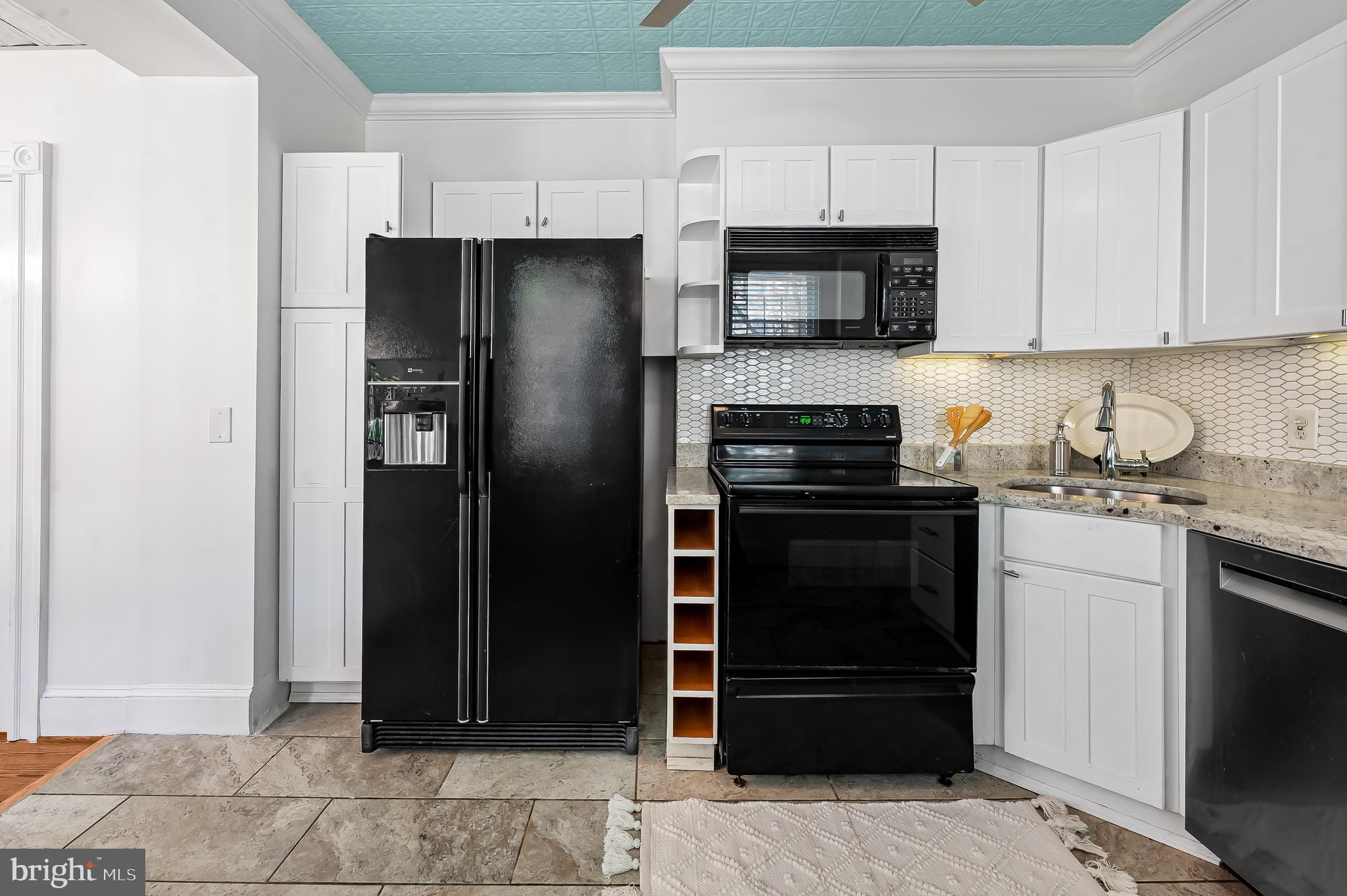 748 Ramsay Street Baltimore, MD 21230 - Photo 13 of 36 a kitchen with a refrigerator and a stove