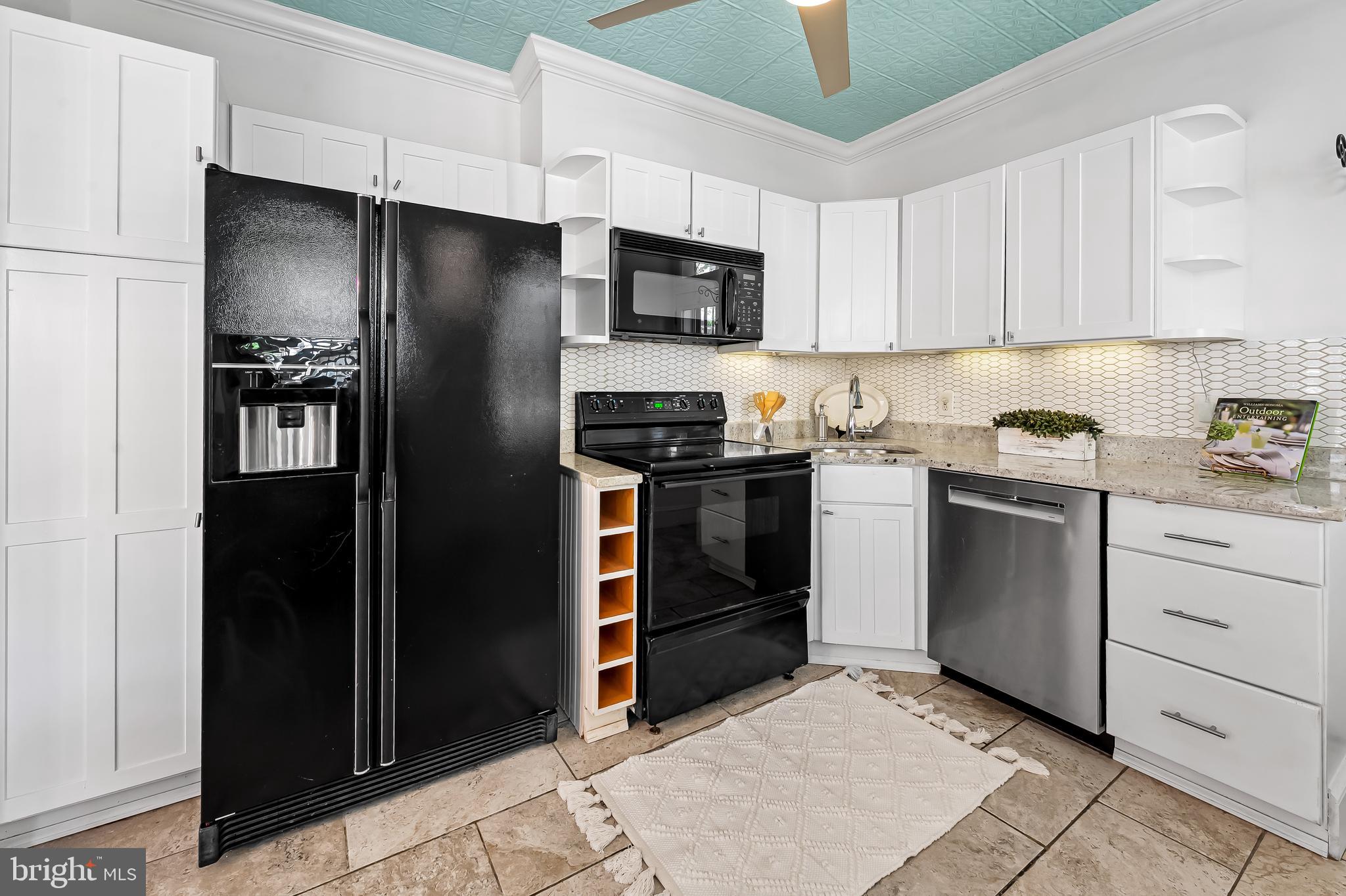 748 Ramsay Street Baltimore, MD 21230 - Photo 14 of 36 a kitchen with white cabinets and stainless steel appliances