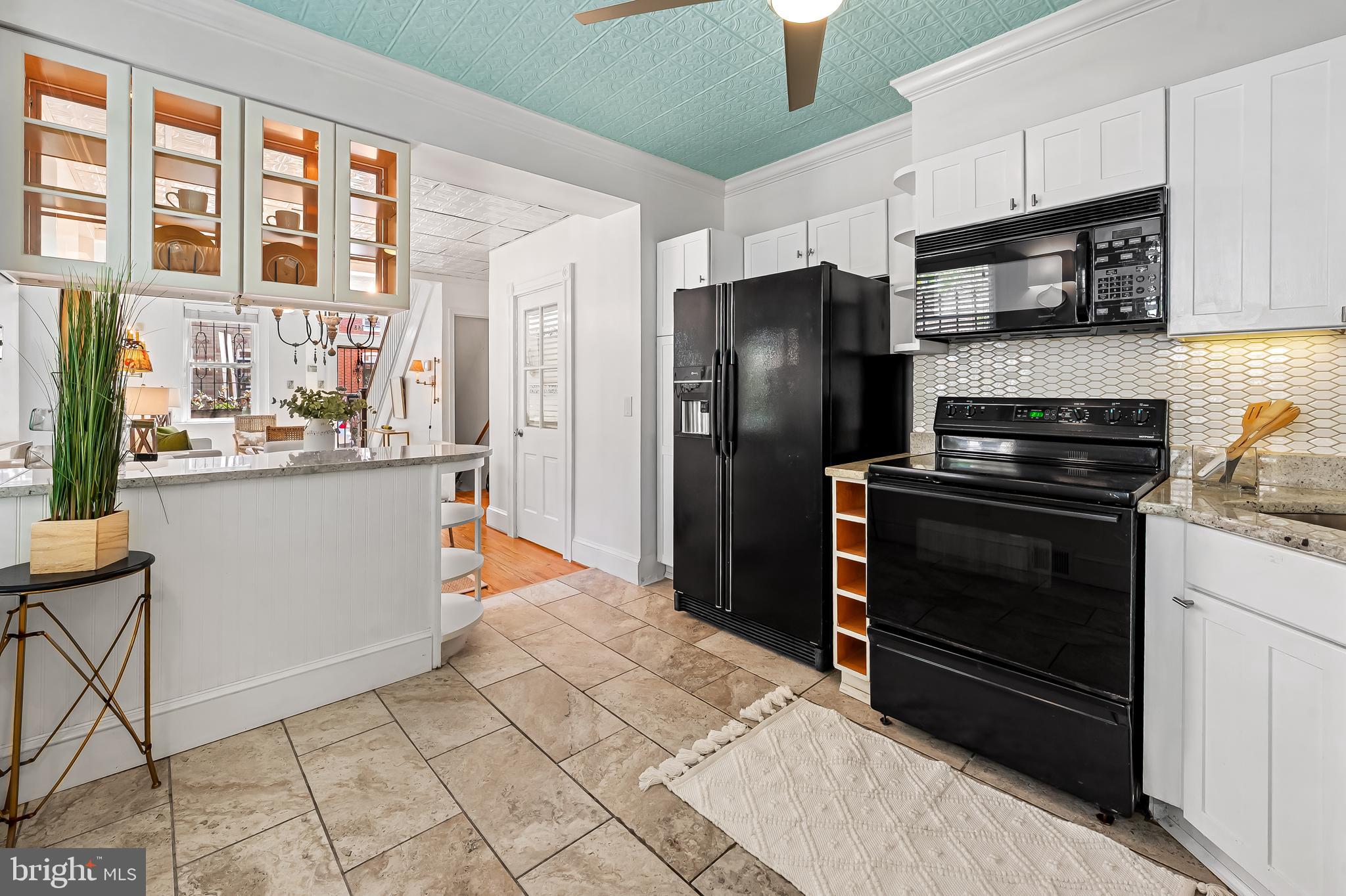 748 Ramsay Street Baltimore, MD 21230 - Photo 15 of 36 a kitchen with stainless steel appliances a stove a refrigerator and a sink