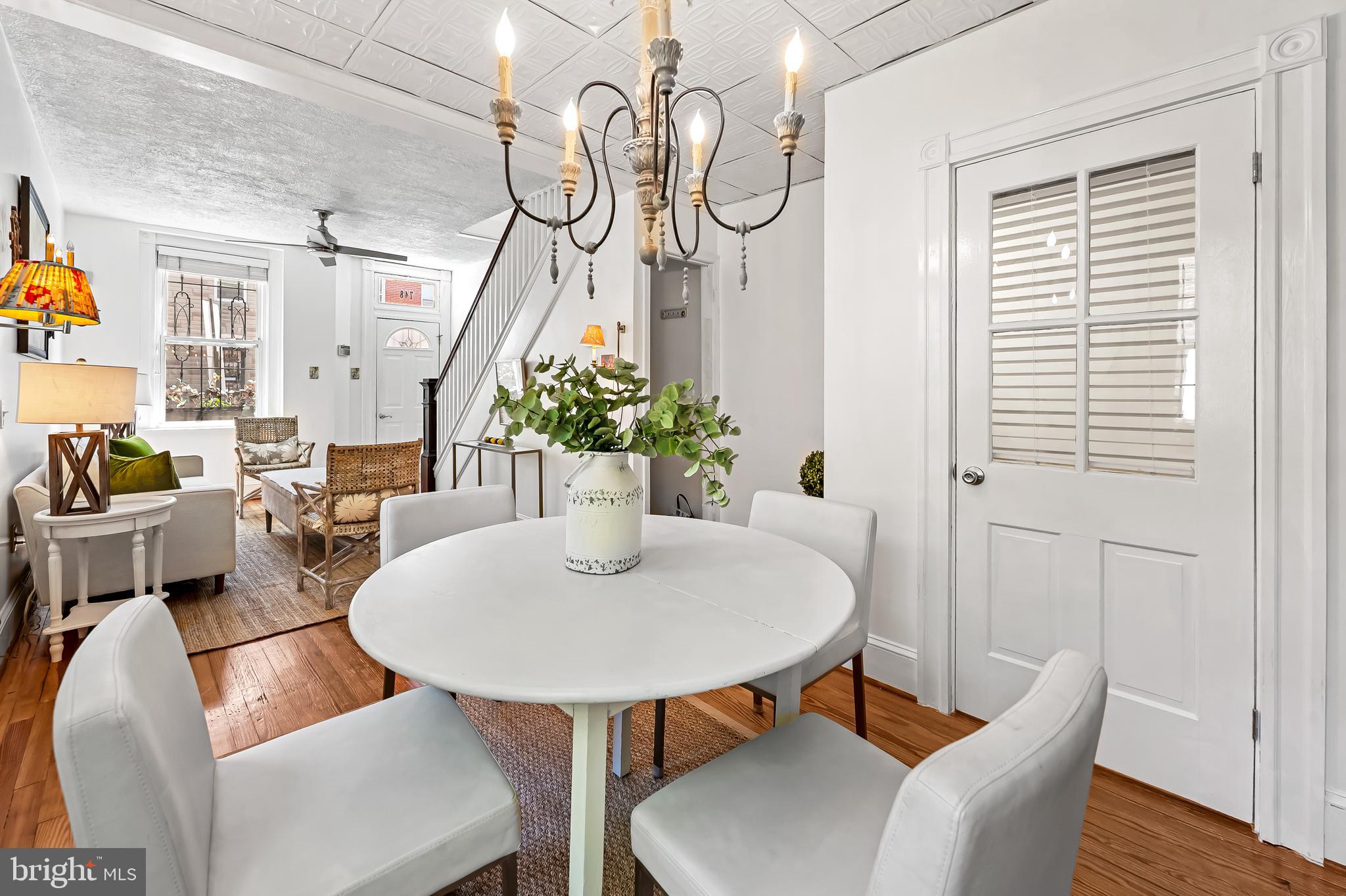 748 Ramsay Street Baltimore, MD 21230 - Photo 10 of 36 a view of a dining room with furniture wooden floor and a chandelier
