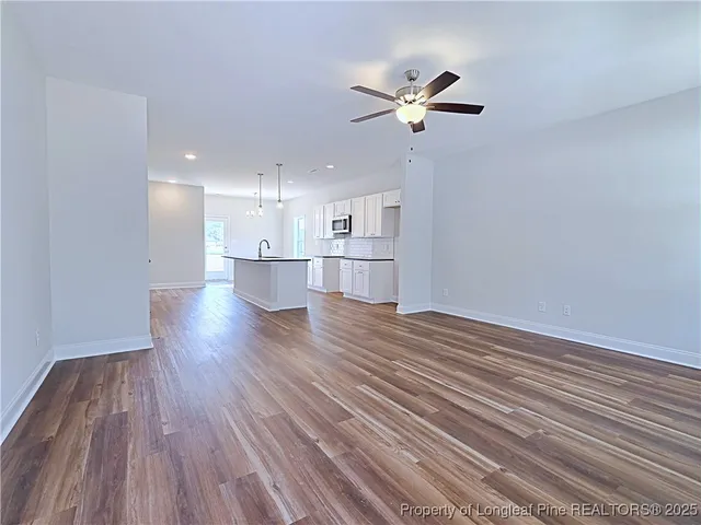 a view of a kitchen with a dishwasher and wooden floor