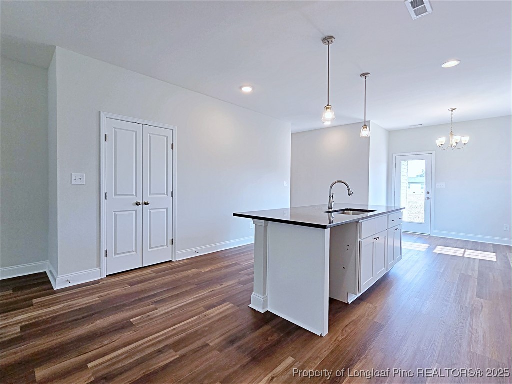 1554 Piney Grove Road Lumberton, NC 28360 - Photo 5 of 27 a kitchen with stainless steel appliances granite countertop a stove a sink a refrigerator and a wooden floor