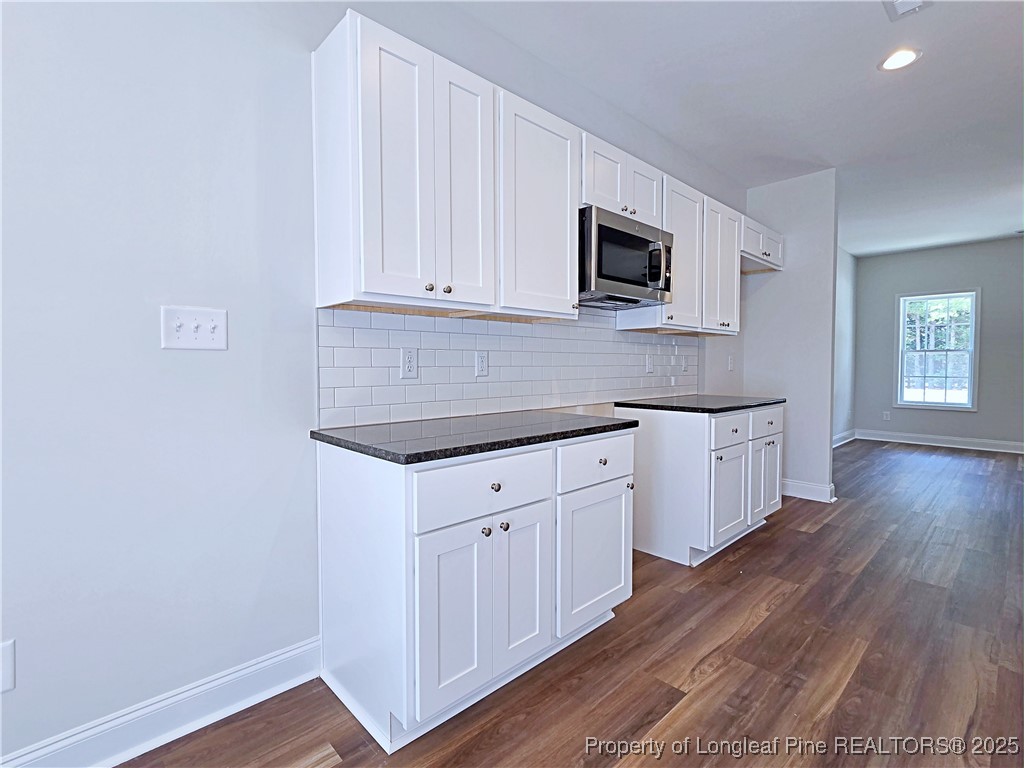 1554 Piney Grove Road Lumberton, NC 28360 - Photo 8 of 27 a kitchen with stainless steel appliances white cabinets and a wooden floor