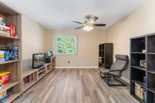 a view of a workspace with furniture and a window