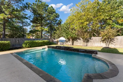 a view of swimming pool with a yard