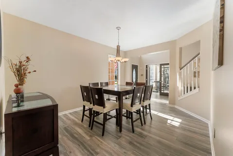 a dining room with furniture window and wooden floor