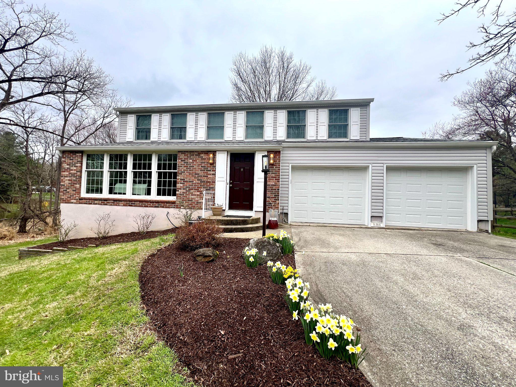 Charming home with blooming daffodils.