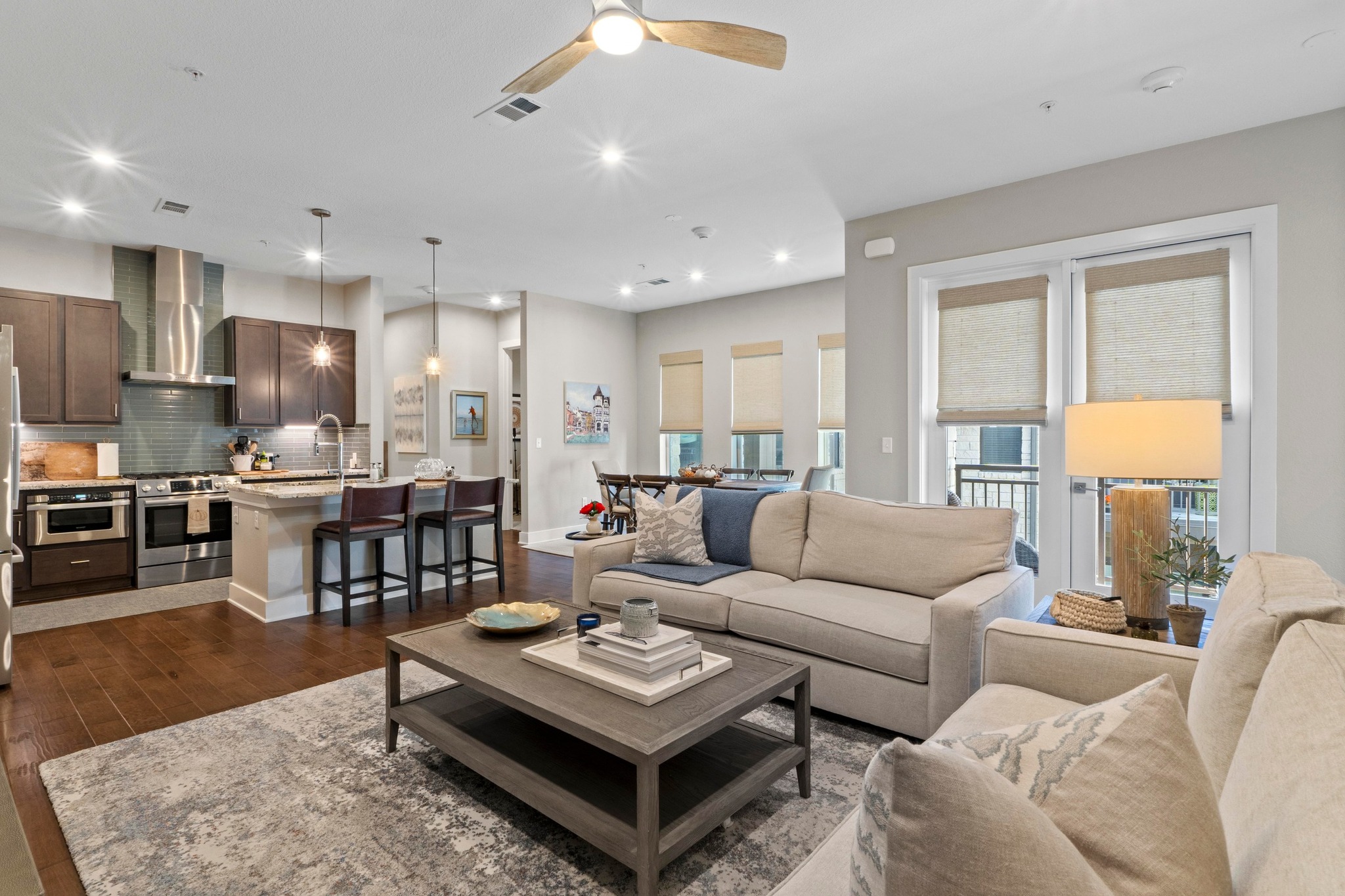 a living room kitchen with a couch and a dining table