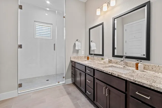 a bathroom with a granite countertop sink mirror and double