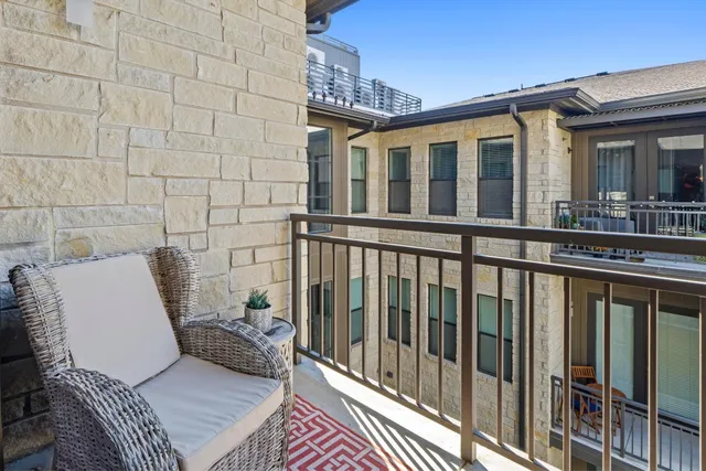 a view of a balcony with furniture