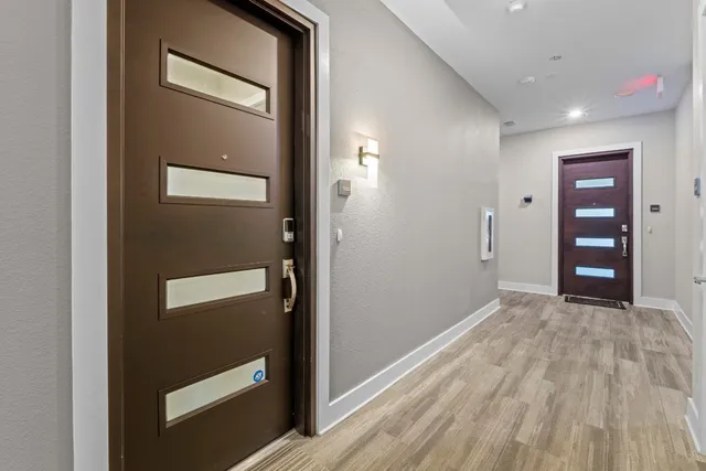 a view of empty room with wooden floor