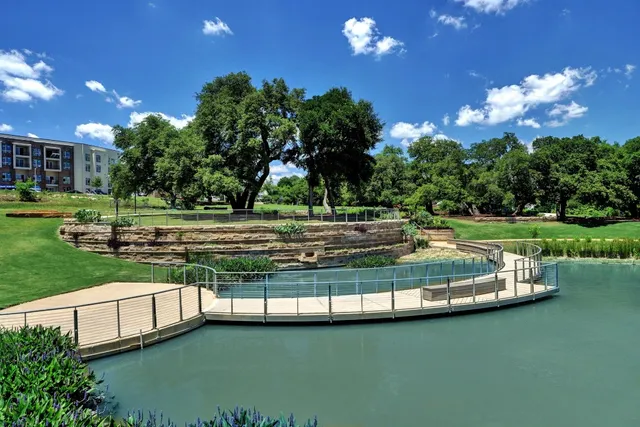 a view of a lake with a yard and outdoor seating