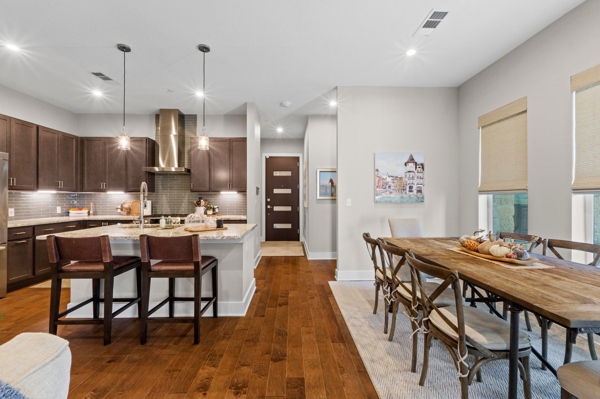 4501 Jackson Avenue, Unit 5302 Austin, TX 78731 - Photo 4 of 38 a dining room with stainless steel appliances kitchen island granite countertop a dining table chairs and a refrigerator