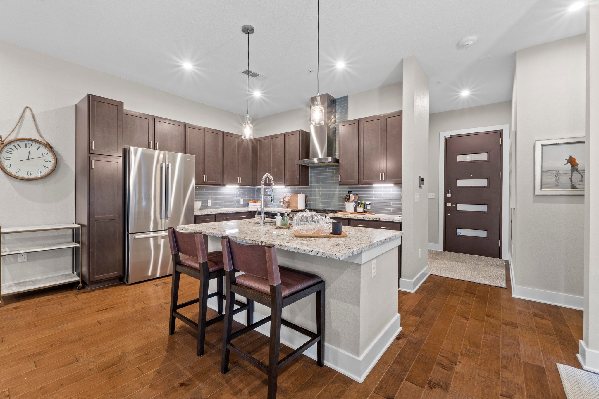 4501 Jackson Avenue, Unit 5302 Austin, TX 78731 - Photo 5 of 38 a kitchen with stainless steel appliances kitchen island granite countertop a refrigerator and a stove top oven