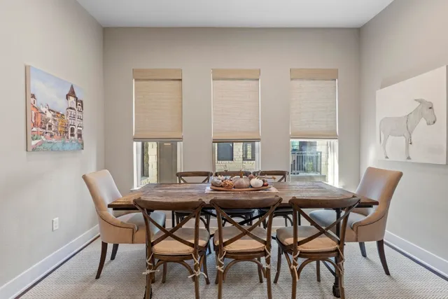 a view of a dining room with furniture and window