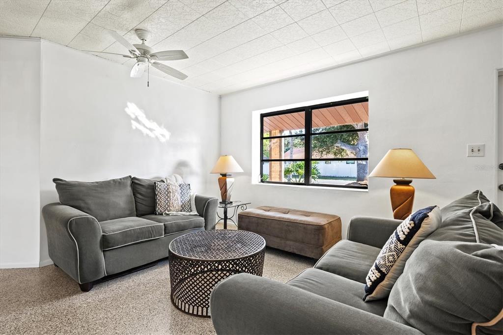 148 Roberts Road Nokomis, FL 34275 - Photo 13 of 68 a living room with furniture a lamp and a window