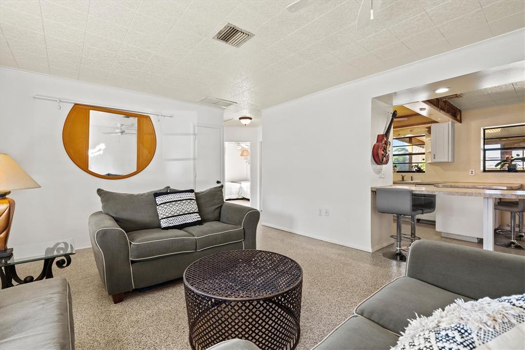 148 Roberts Road Nokomis, FL 34275 - Photo 16 of 68 a living room with furniture a mirror and a lamp