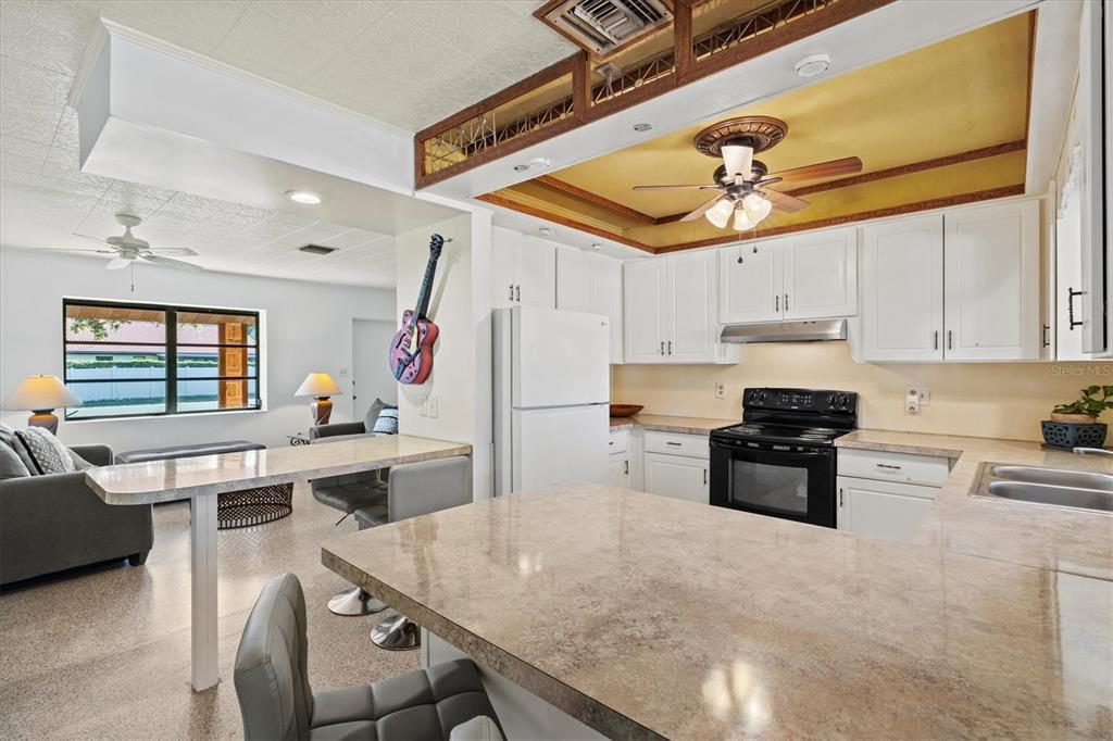 148 Roberts Road Nokomis, FL 34275 - Photo 17 of 68 a kitchen with a stove a refrigerator and a stove top oven