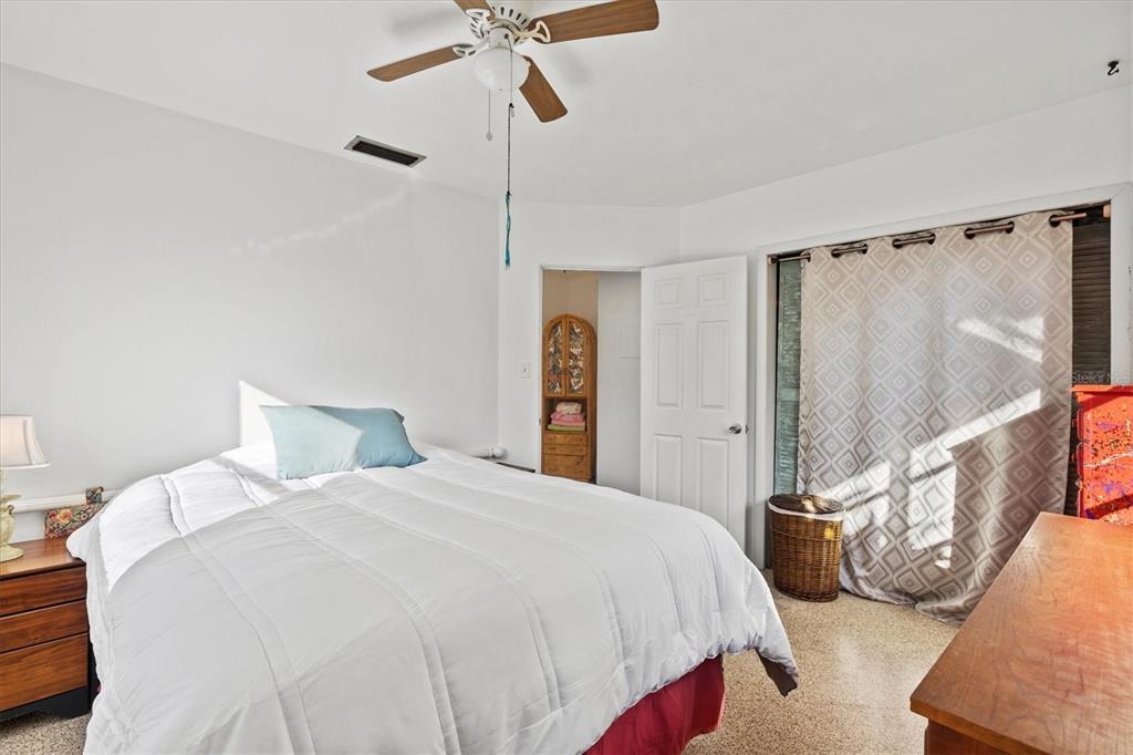 148 Roberts Road Nokomis, FL 34275 - Photo 25 of 68 a bedroom with a bed and a chandelier