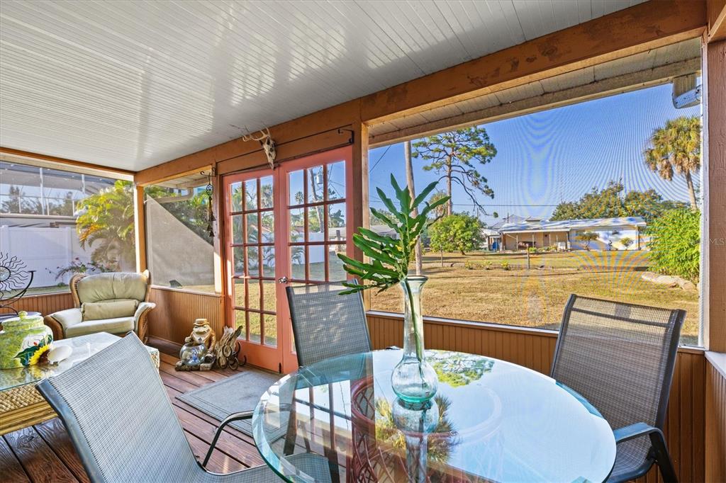 148 Roberts Road Nokomis, FL 34275 - Photo 31 of 68 a view of a dining room with furniture a potted plant and wooden floor