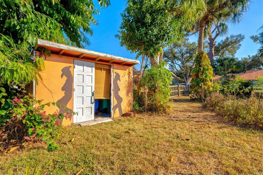 148 Roberts Road Nokomis, FL 34275 - Photo 44 of 68 a front view of a house with a large tree