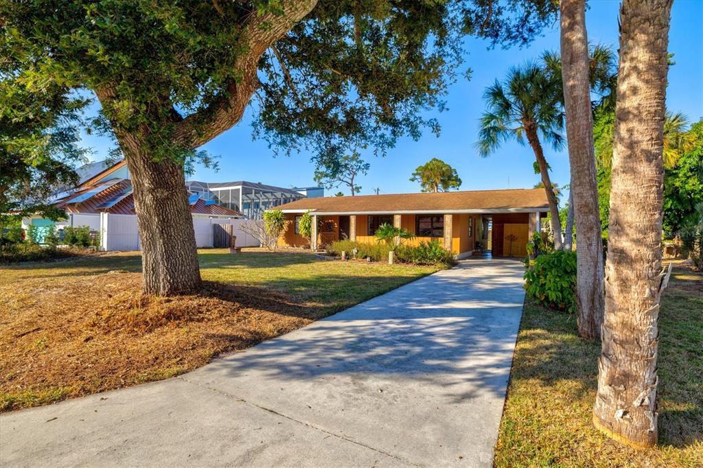 148 Roberts Road Nokomis, FL 34275 - Photo 48 of 68 a front view of a house with a garden
