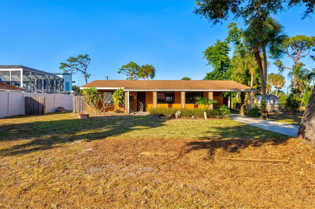 148 Roberts Road Nokomis, FL 34275 - Photo 49 of 68 a view of a house with a yard