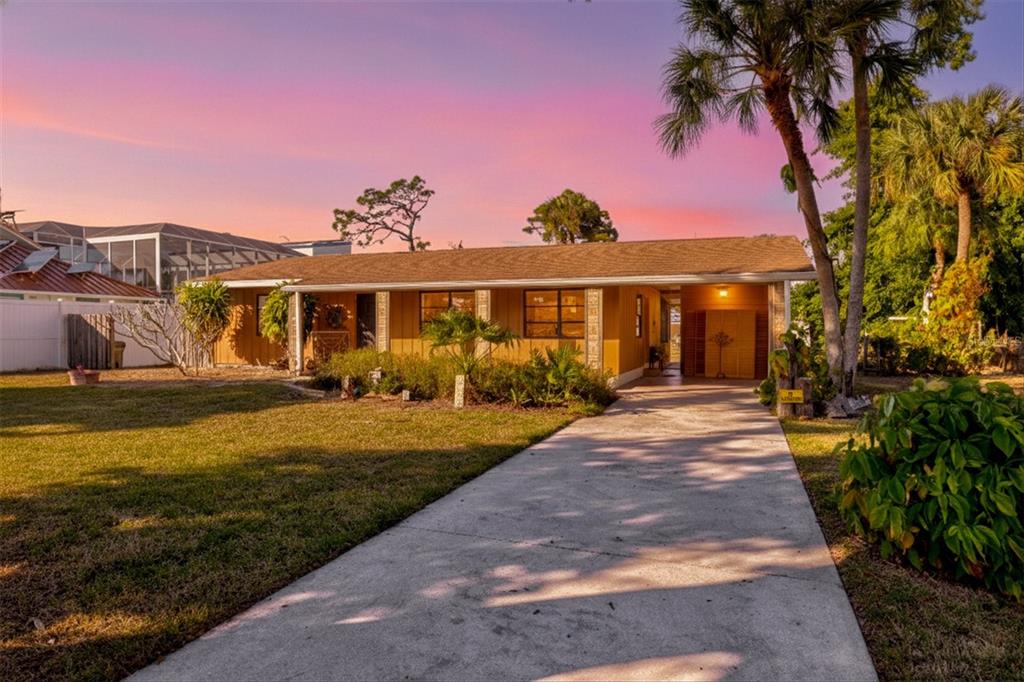 148 Roberts Road Nokomis, FL 34275 - Photo 10 of 68 a front view of a house with garden