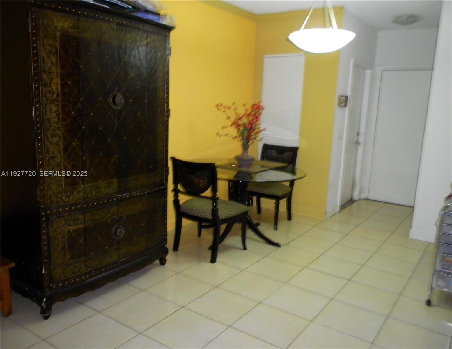 2493 Centergate Drive, Unit 102 Miramar, FL 33025 - Photo 3 of 10 a view of a livingroom with furniture and chandelier fan