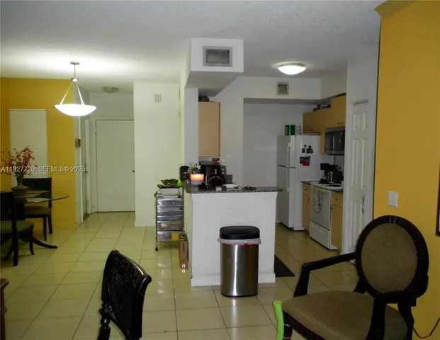 a view of kitchen and dining area with furniture