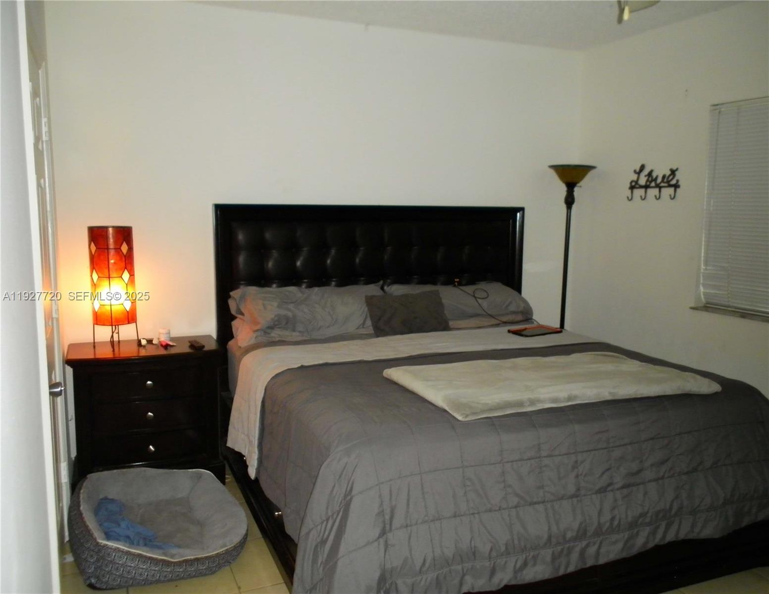 2493 Centergate Drive, Unit 102 Miramar, FL 33025 - Photo 6 of 10 a bedroom with a bed and window