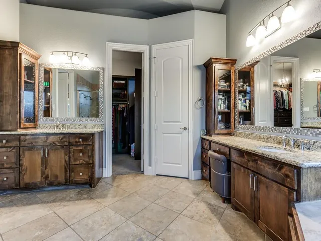 a spacious bathroom with a granite countertop sink and a mirror