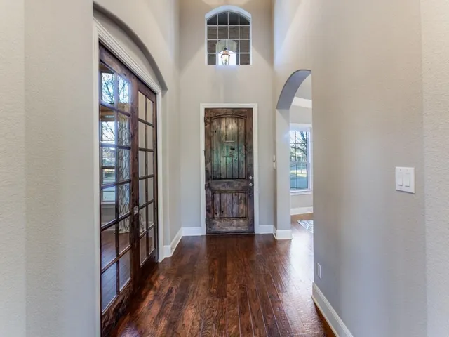 wooden floor in a hall with a window