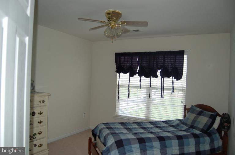 8312 Banister Road Severn, MD 21144 - Photo 17 of 21 a bedroom with a bed and a window