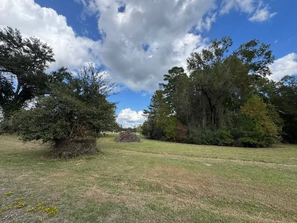 a sign board with yard in the back