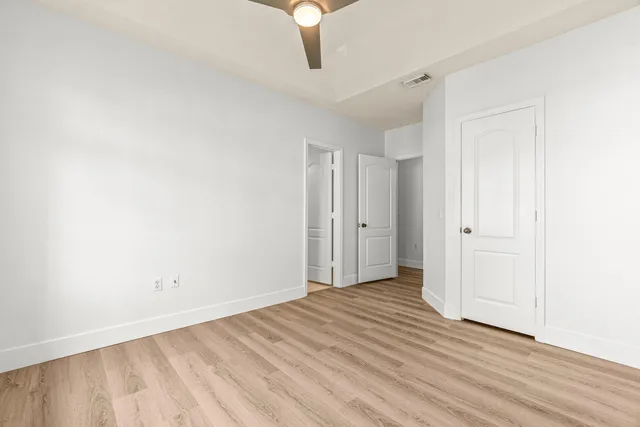 a view of an empty room with wooden floor