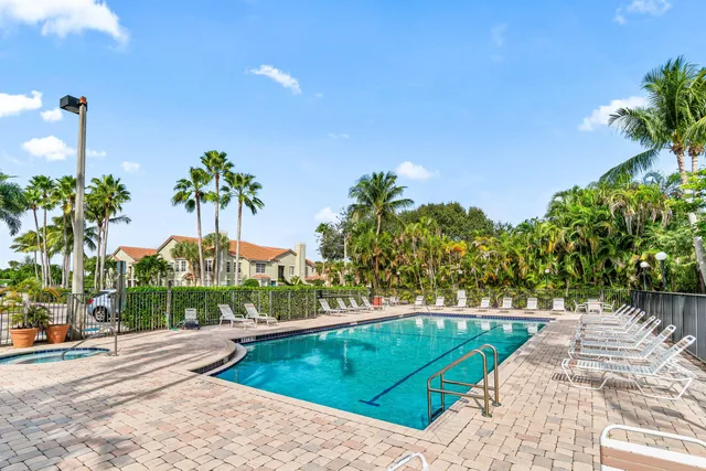 a view of a swimming pool with a yard