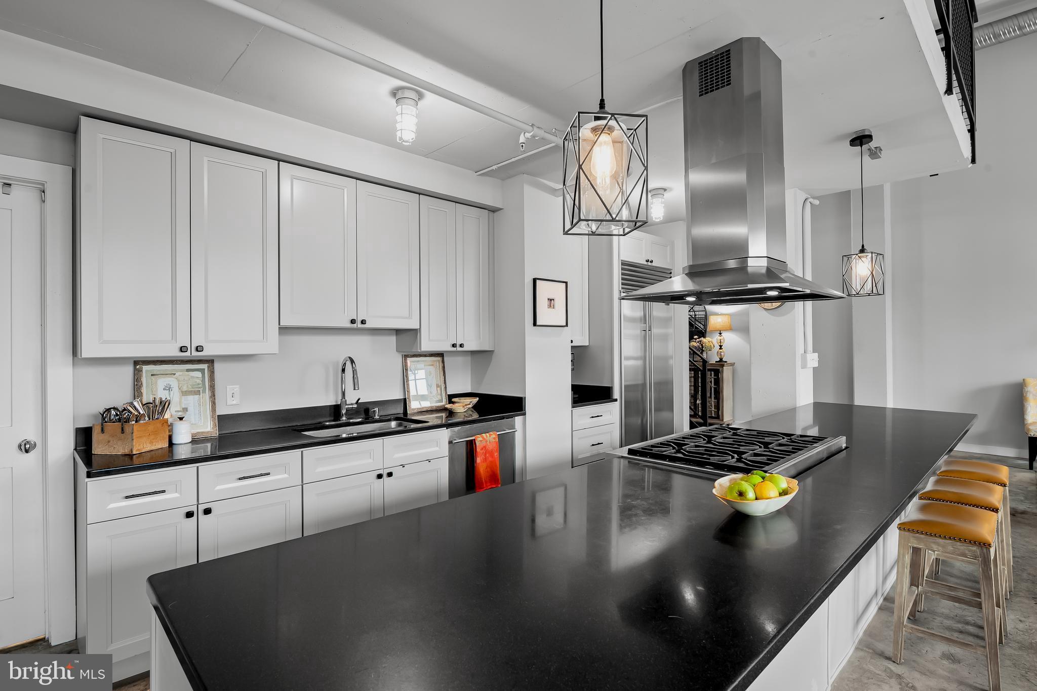 1220 Bank Street, Unit 309 Baltimore, MD 21202 - Photo 21 of 56 a kitchen with stainless steel appliances granite countertop a sink a stove and a refrigerator